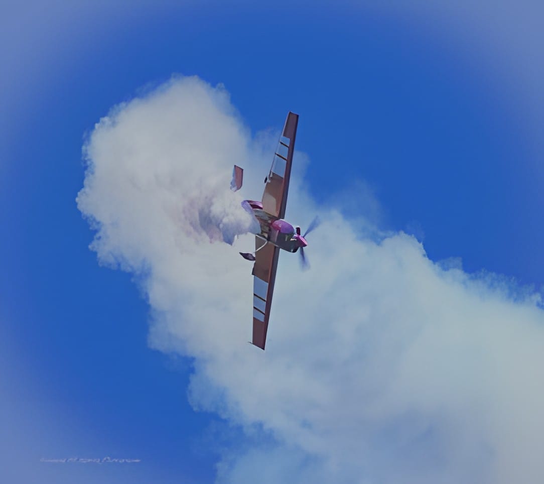 A single aerobatic plane in a cloud of its own smoke