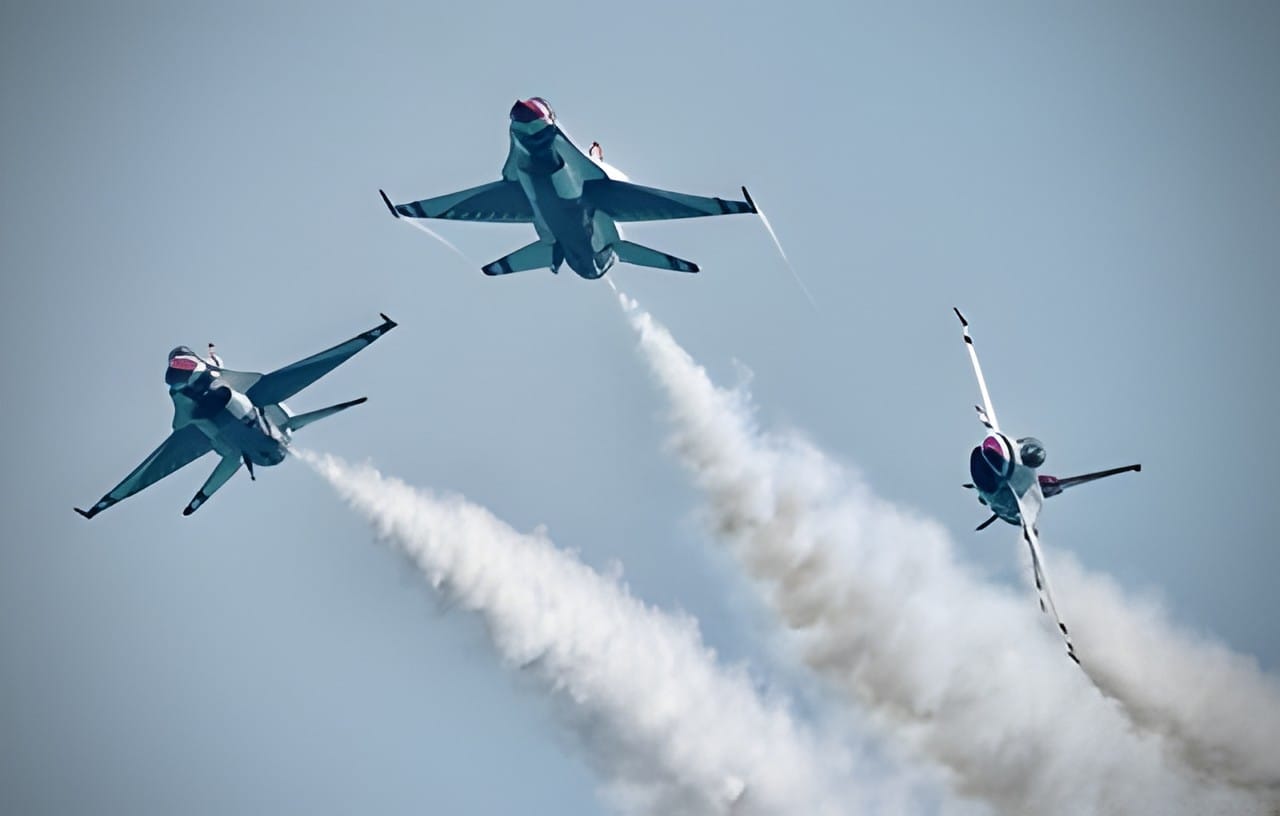 Two Thunderbirds jets crossing in opposite directions