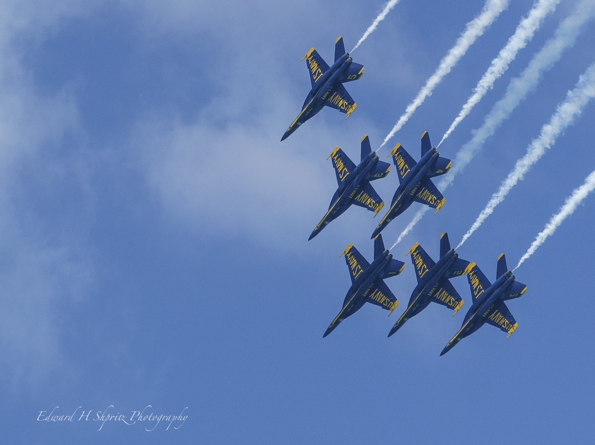 Blue Angels jets bank in a sweeping formation. — by Ed Shpritz