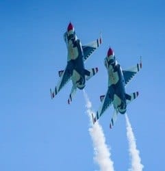 Two jets climb side by side with smoke trails. — by Ed Shpritz