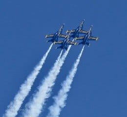 Three Blue Angels jets climb together with smoke trails. — by Ed Shpritz
