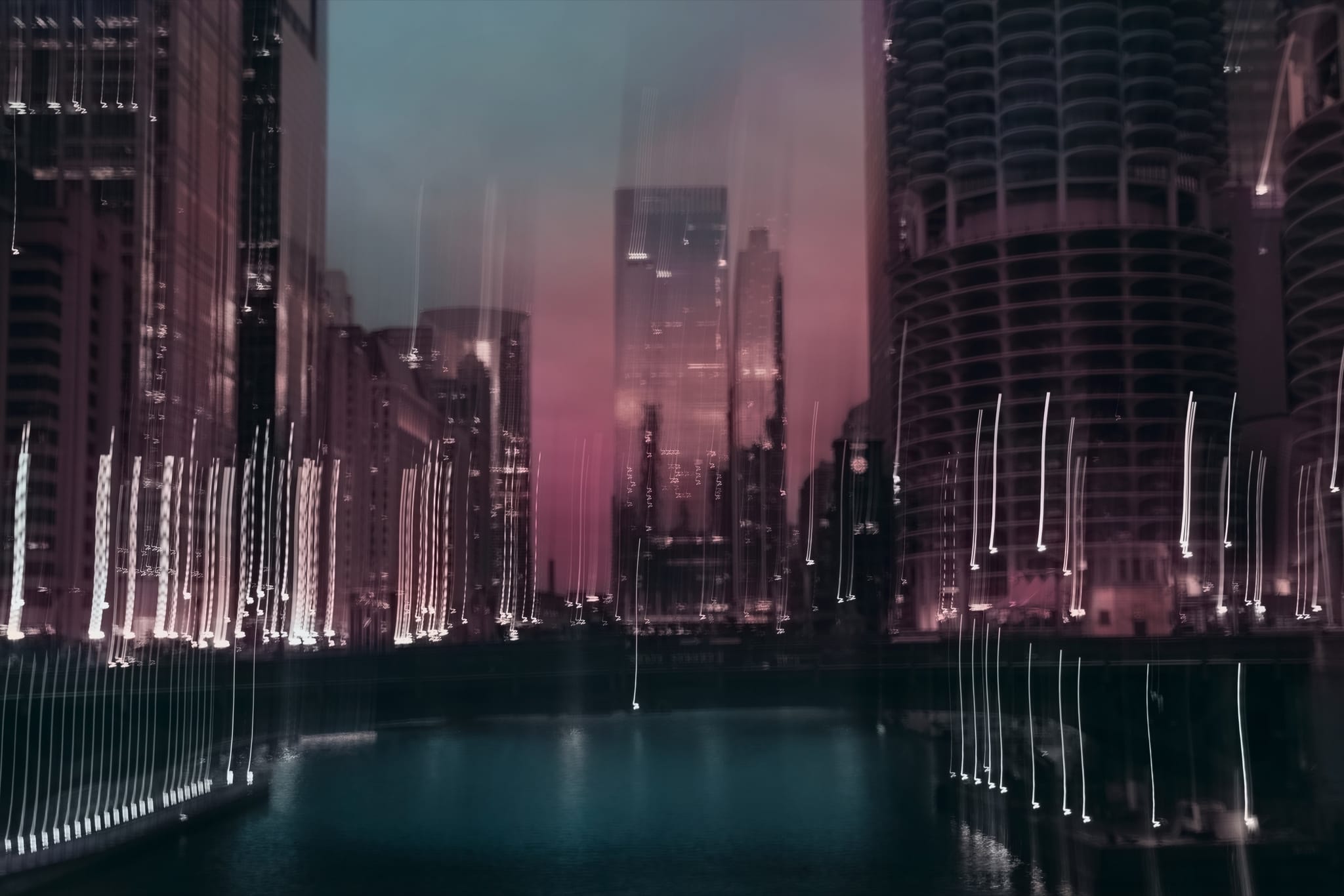 A magenta and blue city canyon with lights drawn into delicate vertical trails