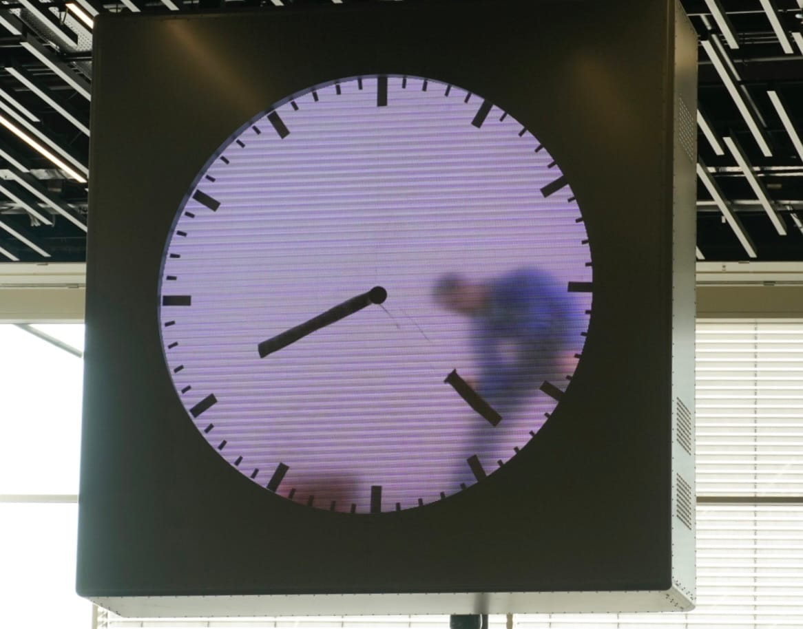 Blurred runner moving through a clock face
