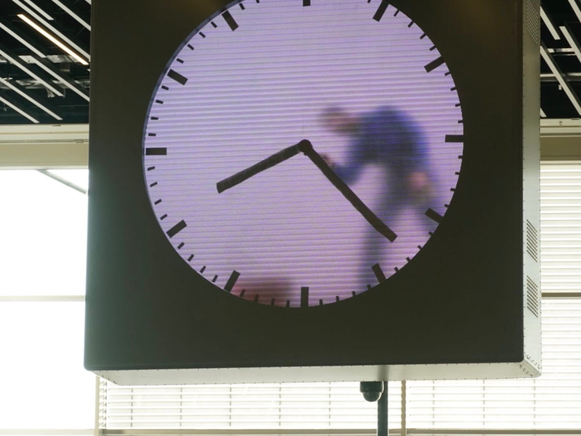 Blurred figure walking through a clock face