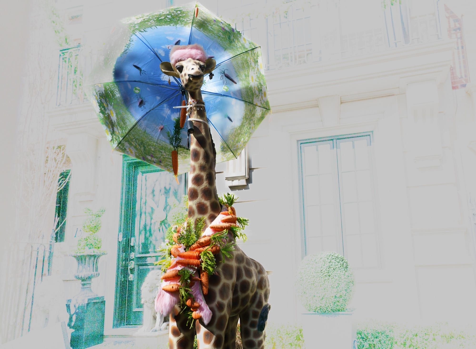 Decorated giraffe beneath an umbrella