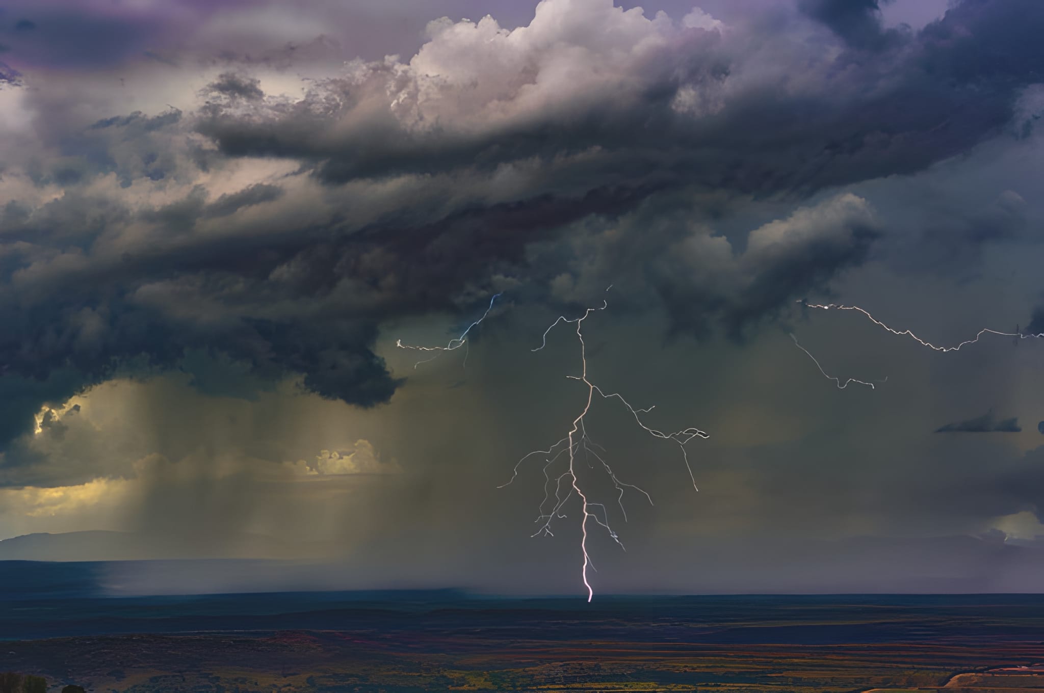 Lightning beneath a purple storm cell — by Ed Shpritz