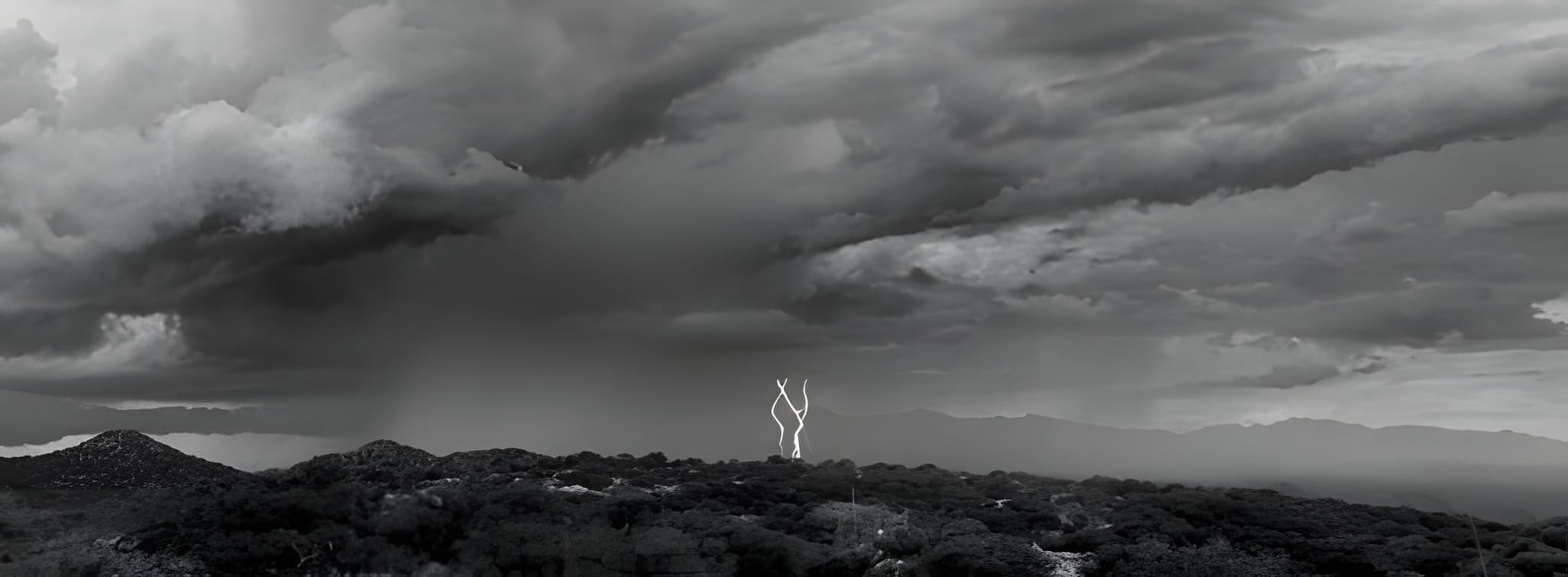Forked lightning over the ridge, black and white — by Ed Shpritz