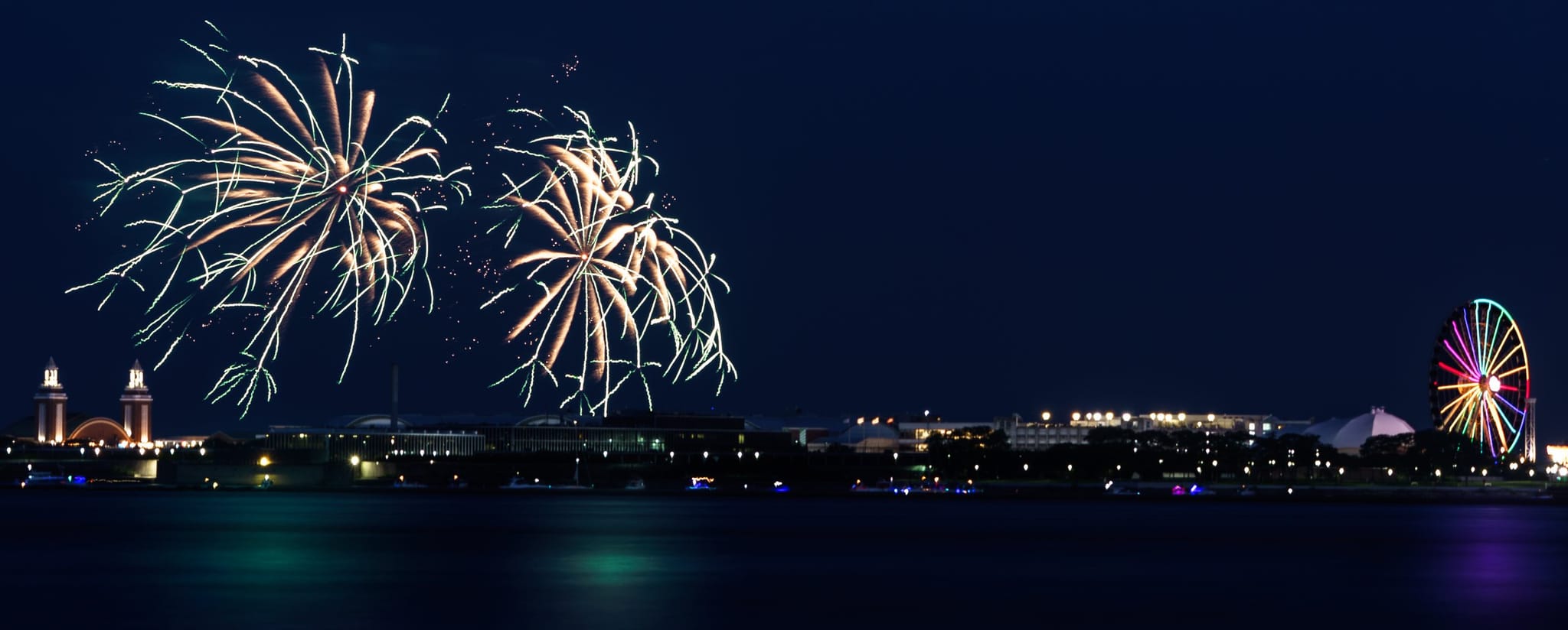 Fourth of July fireworks over Navy Pier and their colored reflections on the lake
