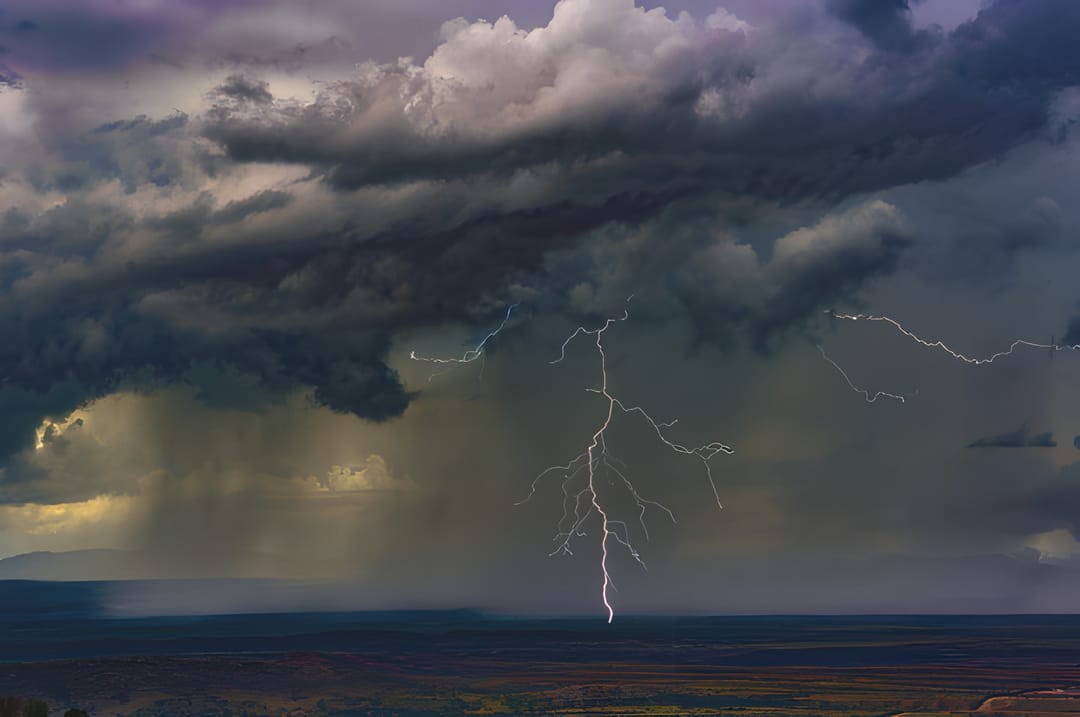 Lightning beneath a purple storm cell — by Ed Shpritz