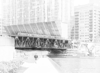 A Chicago bascule railroad bridge raised over the river in high key black and white