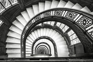 A spiral staircase seen from above, black and white