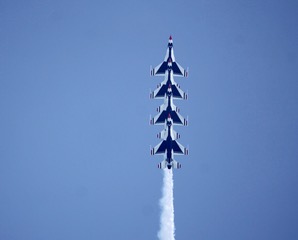 Four Thunderbirds jets climbing vertically in formation
