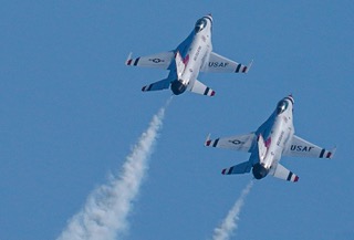Two Thunderbirds jets trailing white smoke
